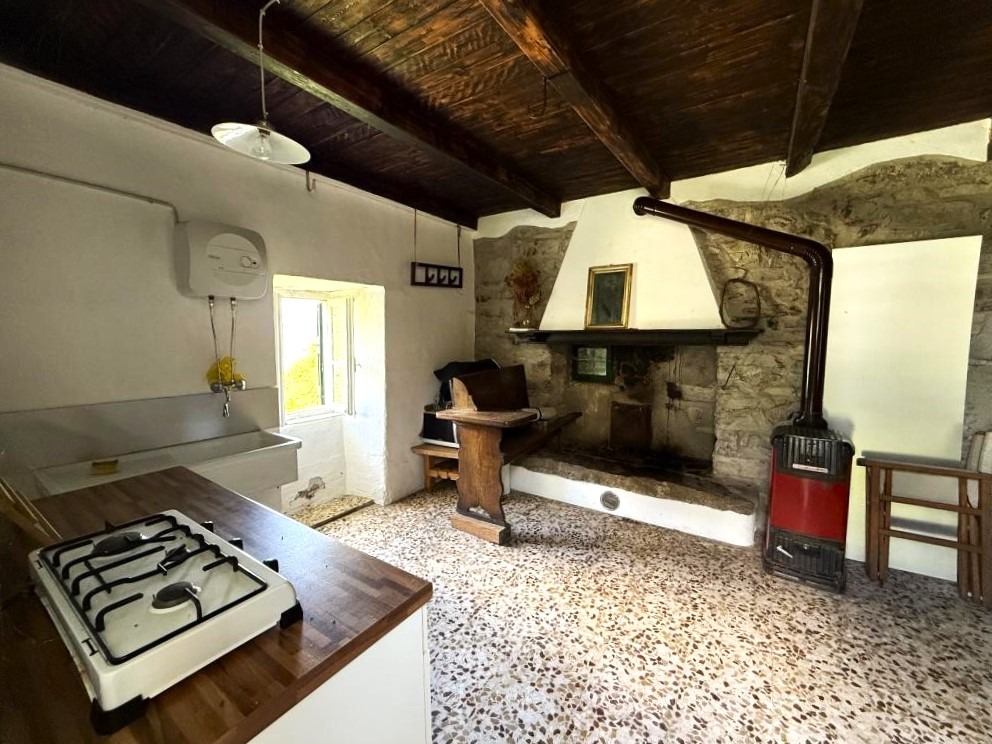 2. Stone house near argegno green area